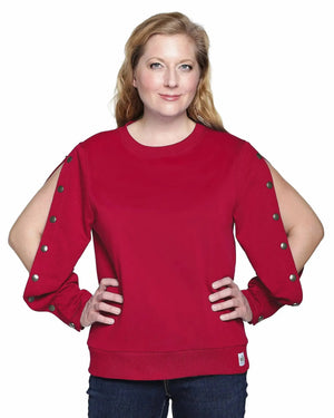 Woman wearing a Wear 2 Conquer Ruby Red color arm port dialysis sweatshirt with black snaps on sleeves against a white background. front view with snaps on both sleeves open