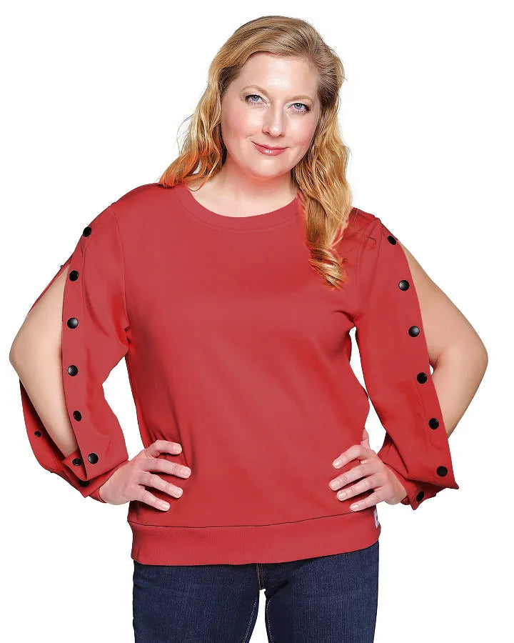 Woman wearing a red dialysis shirt with black button details on a white background